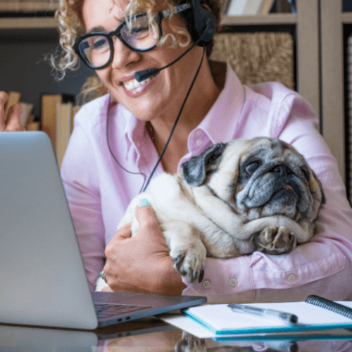 Woman and her dog working on a computer